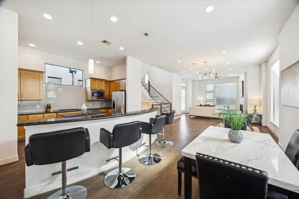 a kitchen with counter and chairs in it