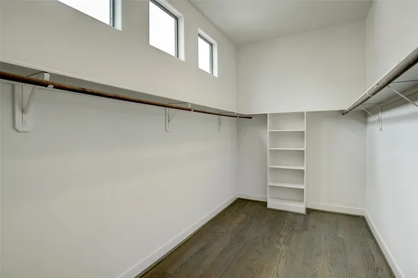 a view of walk in closet with empty racks