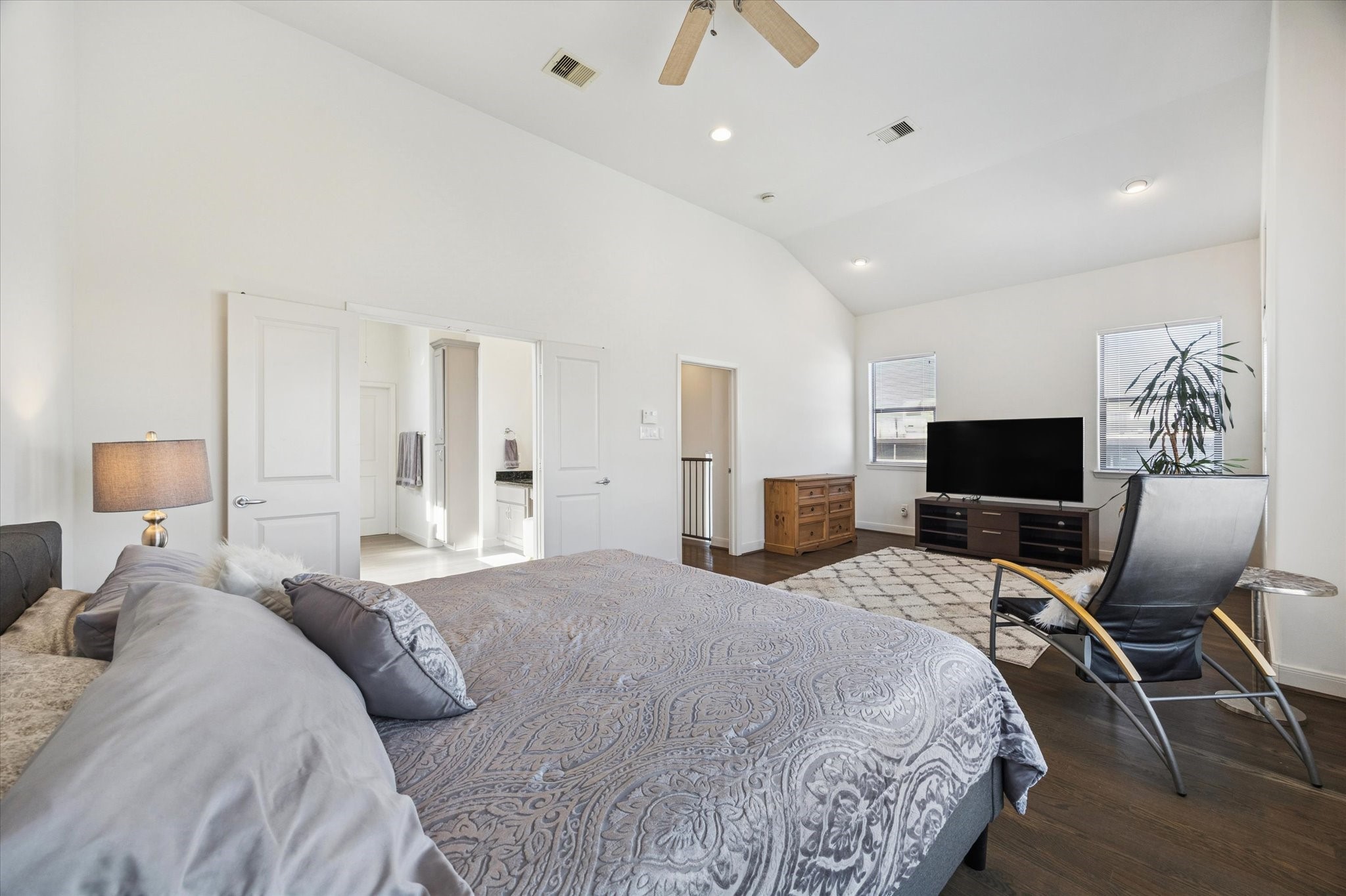 902 Roy Street Houston, TX 77007 - Photo 3 of 50 a large bedroom with bed tv and chair