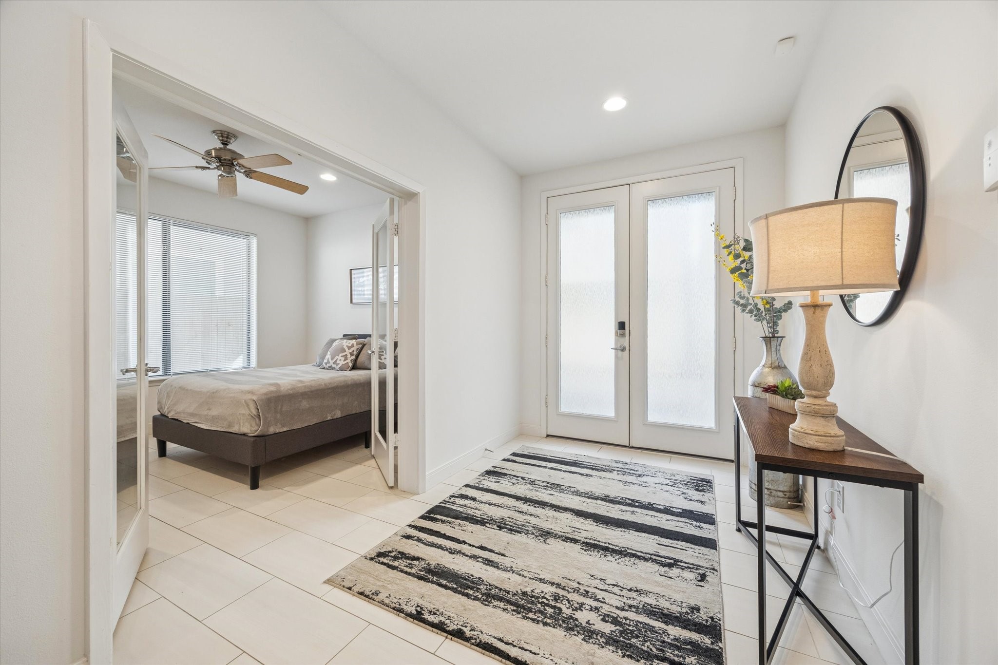 902 Roy Street Houston, TX 77007 - Photo 8 of 50 a bedroom with a bed a mirror and table