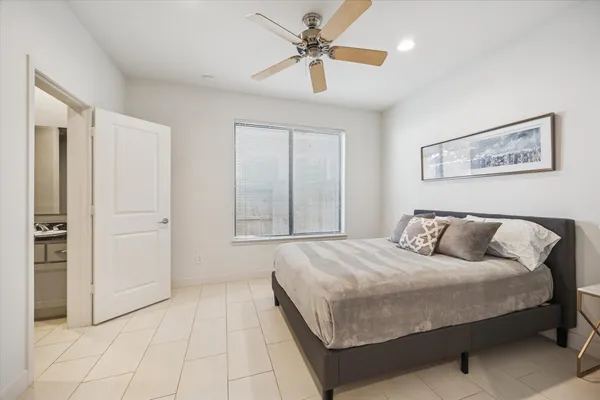 a bedroom with a large bed and a chandelier