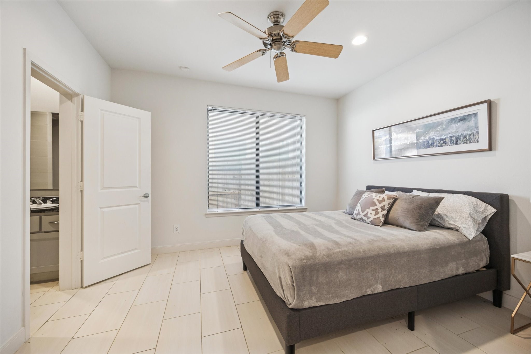 902 Roy Street Houston, TX 77007 - Photo 9 of 50 a bedroom with a large bed and a chandelier