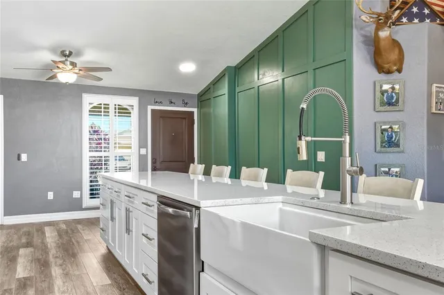 a bathroom with a double vanity sink a large mirror and a bathtub