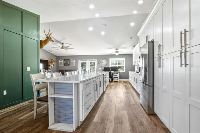 a view of a kitchen with furniture and wooden floor