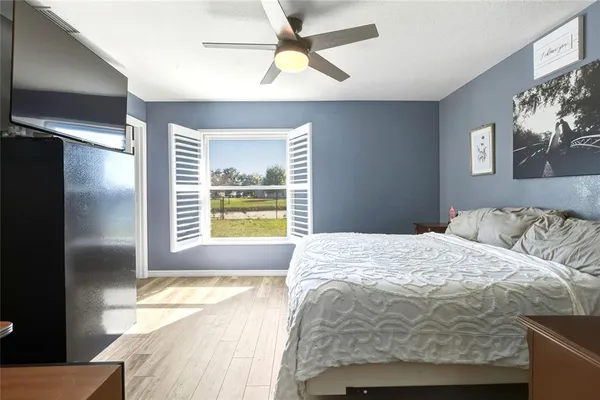 a bedroom with a bed and a chandelier