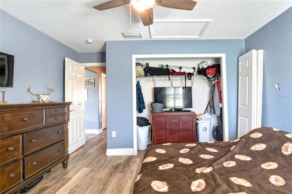 533 Seven Oaks Street Mulberry, FL 33860 - Photo 31 of 43 a bedroom with a bed and wooden floor