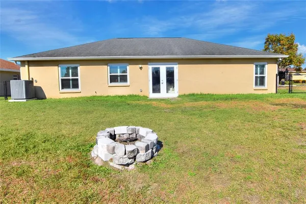 a view of a house with backyard and sitting area