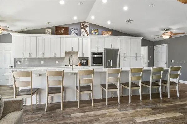 a kitchen with cabinets and chairs