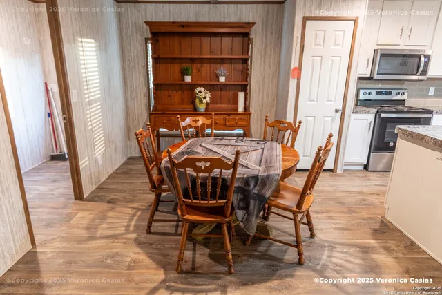 a view of a dining room with furniture and a window