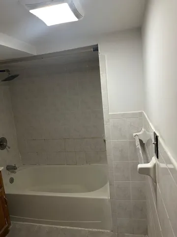 a bathroom with a shower and a bathtub