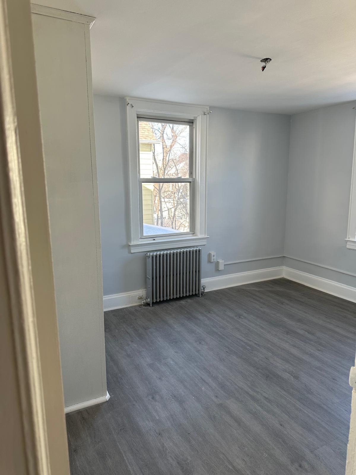 31 East 32nd Street, Unit 2 Bayonne, NJ 07002 - Photo 16 of 19 an empty room with wooden floor and windows