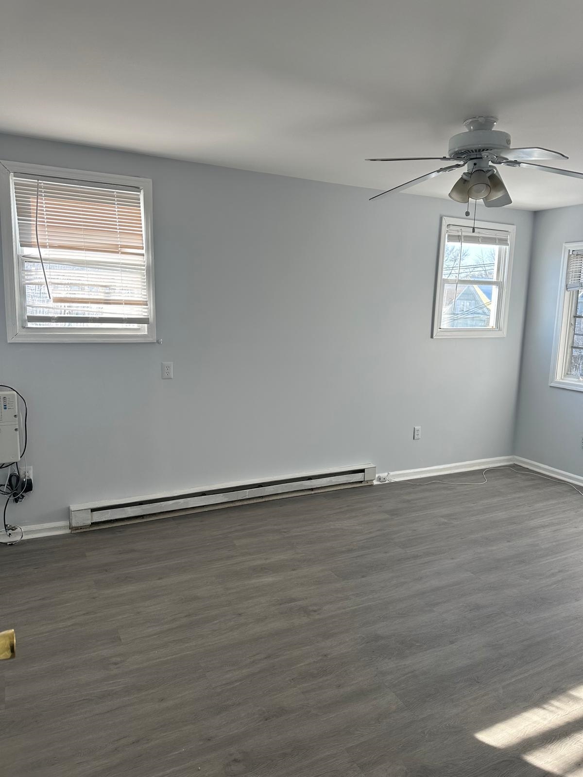 31 East 32nd Street, Unit 2 Bayonne, NJ 07002 - Photo 19 of 19 a view of an empty room with wooden floor and a window