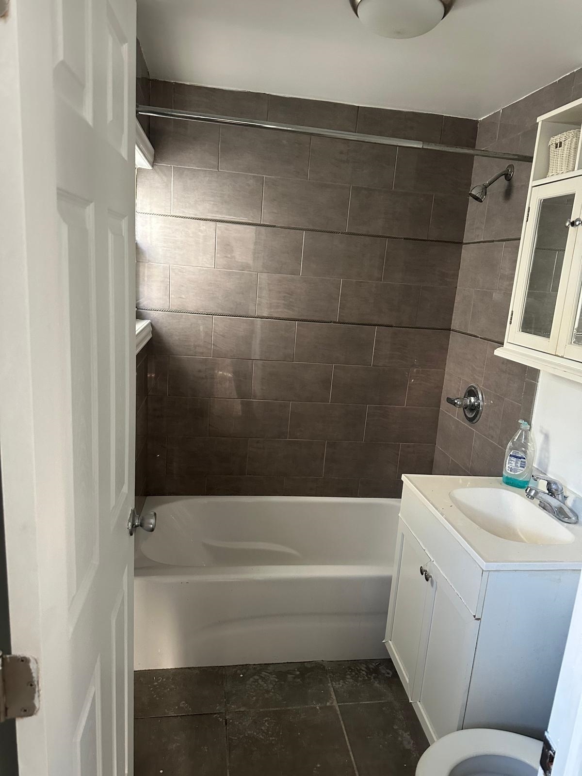 31 East 32nd Street, Unit 2 Bayonne, NJ 07002 - Photo 6 of 19 a bathroom with a bathtub and shower