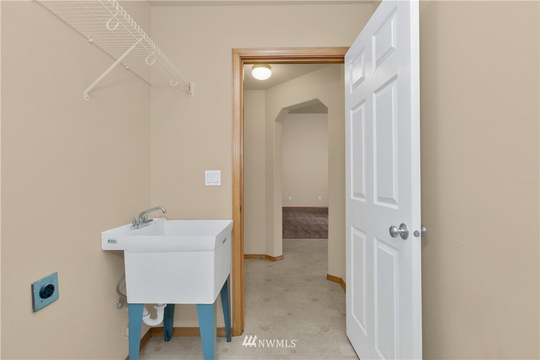 6912 Radius Loop Southeast Lacey, WA 98513 - Photo 14 of 30 a bathroom with a sink mirror and toilet
