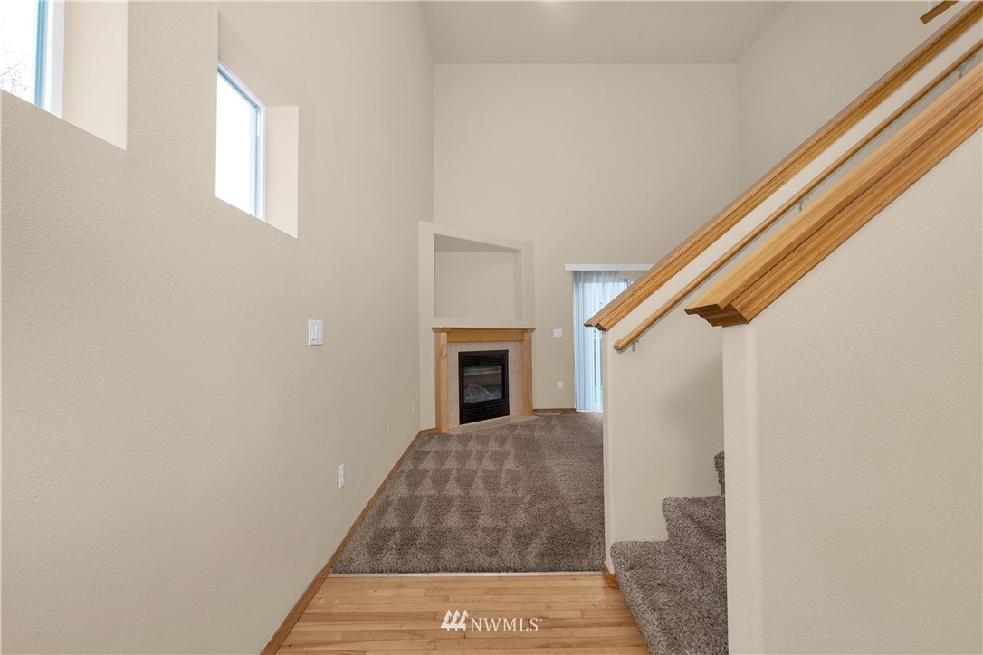 6912 Radius Loop Southeast Lacey, WA 98513 - Photo 3 of 30 a view of a hallway with wooden floor and staircase