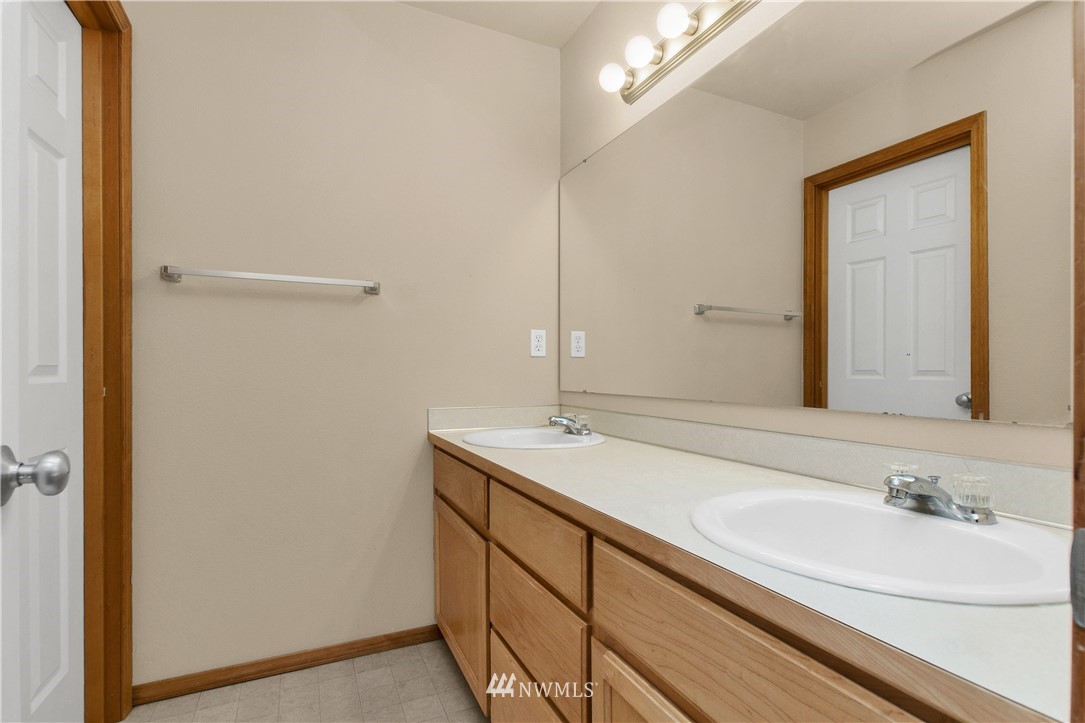6912 Radius Loop Southeast Lacey, WA 98513 - Photo 27 of 30 a bathroom with a sink and a mirror