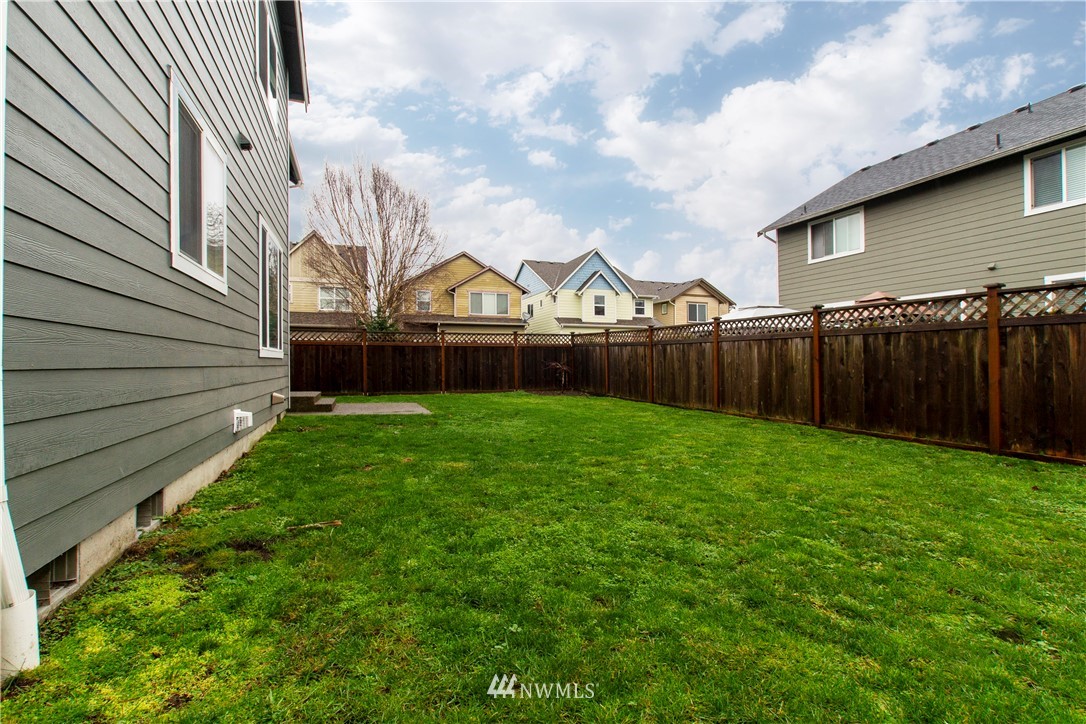 6912 Radius Loop Southeast Lacey, WA 98513 - Photo 29 of 30 a view of a yard in front of a house with a large tree