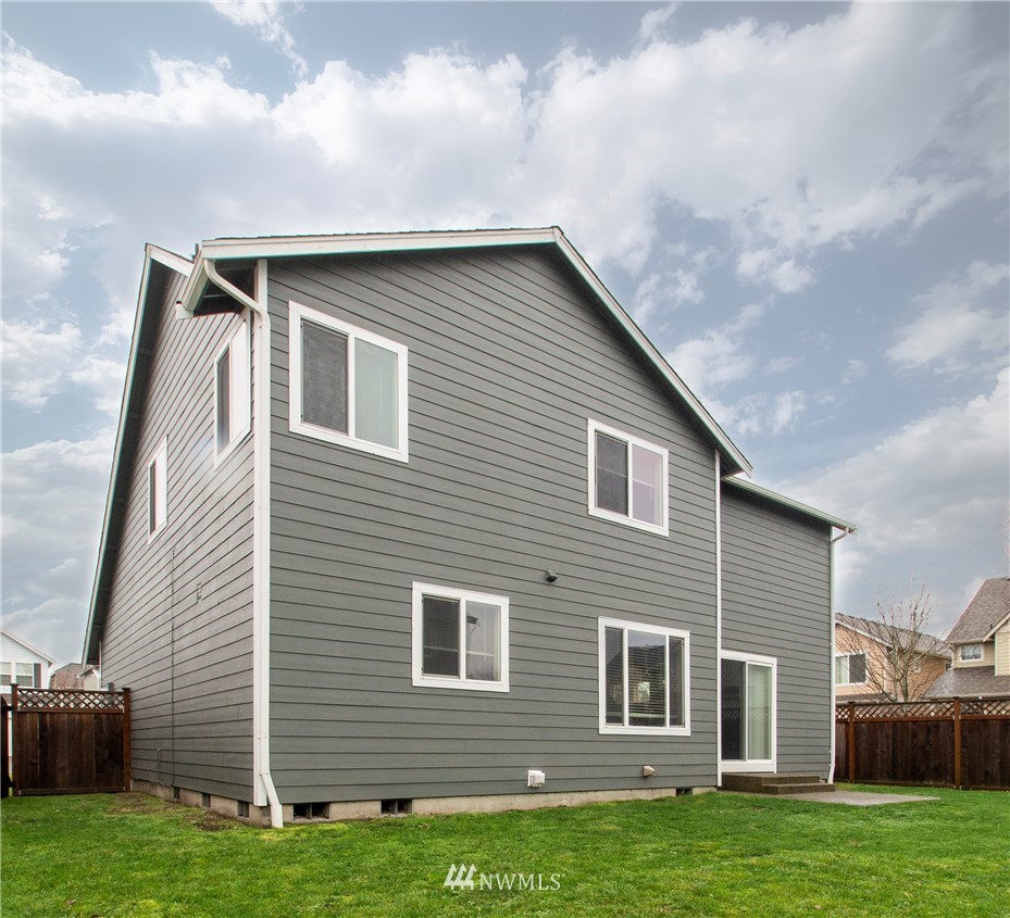 6912 Radius Loop Southeast Lacey, WA 98513 - Photo 30 of 30 a brick house with a yard