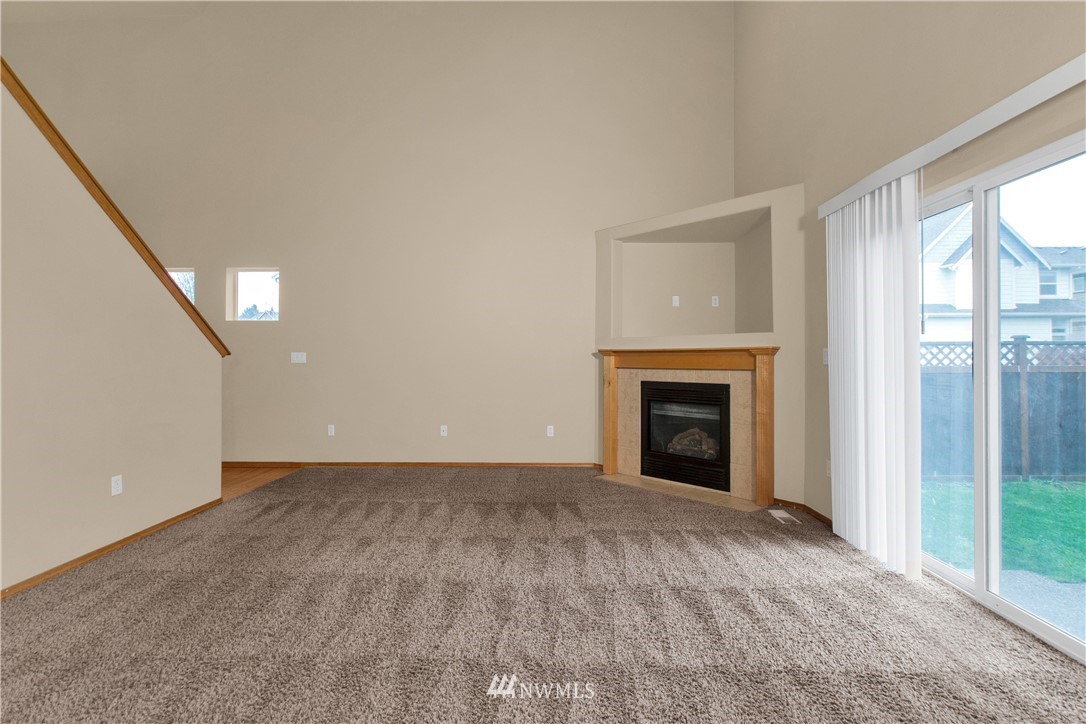 6912 Radius Loop Southeast Lacey, WA 98513 - Photo 4 of 30 a view of an empty room with a window and fireplace