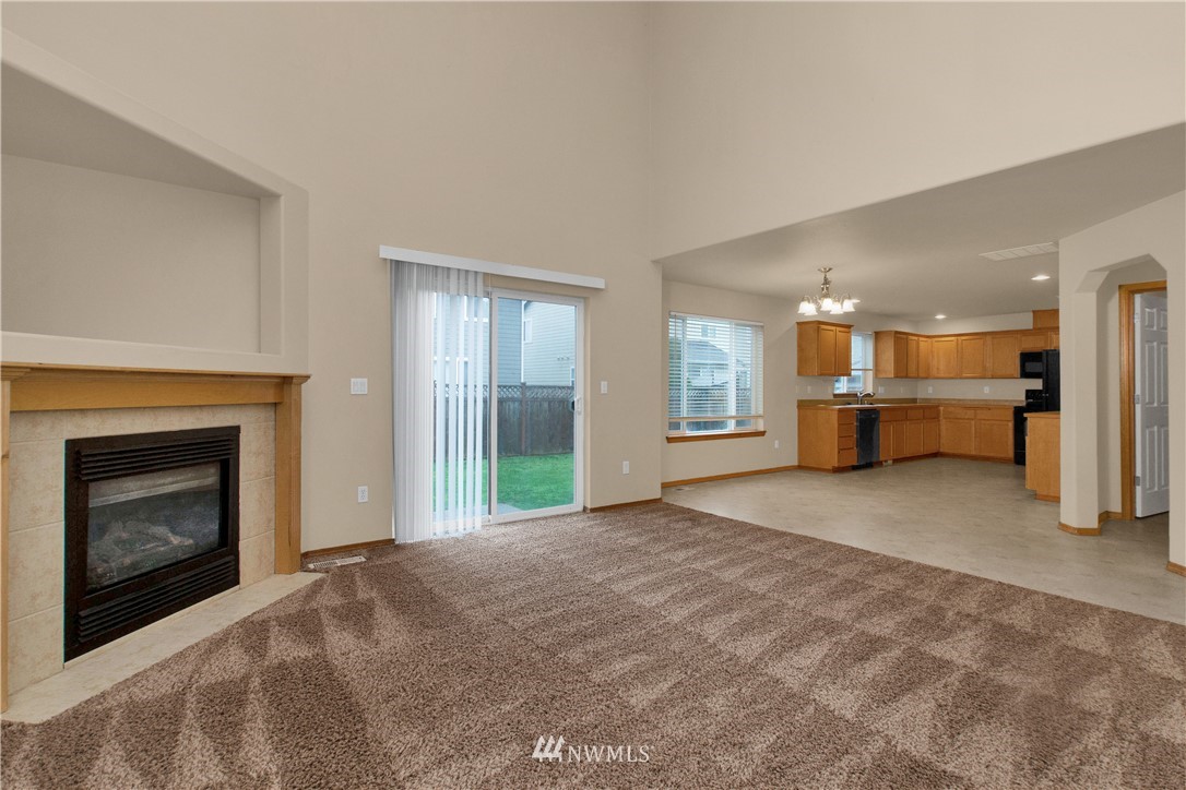 6912 Radius Loop Southeast Lacey, WA 98513 - Photo 5 of 30 a view of a livingroom with a fireplace and a large window