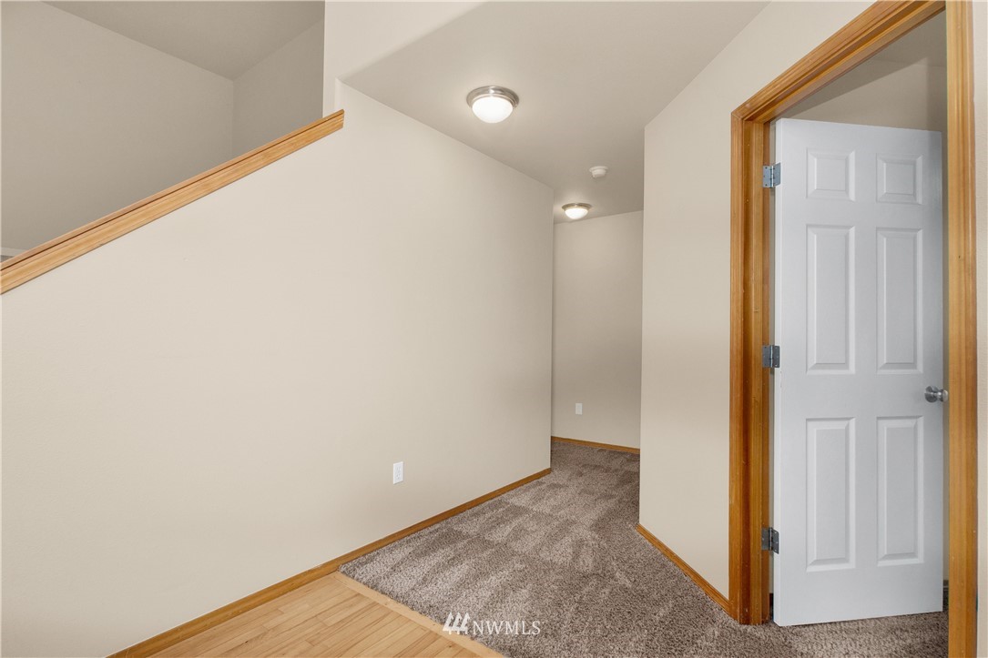 6912 Radius Loop Southeast Lacey, WA 98513 - Photo 8 of 30 an empty room with wooden floor