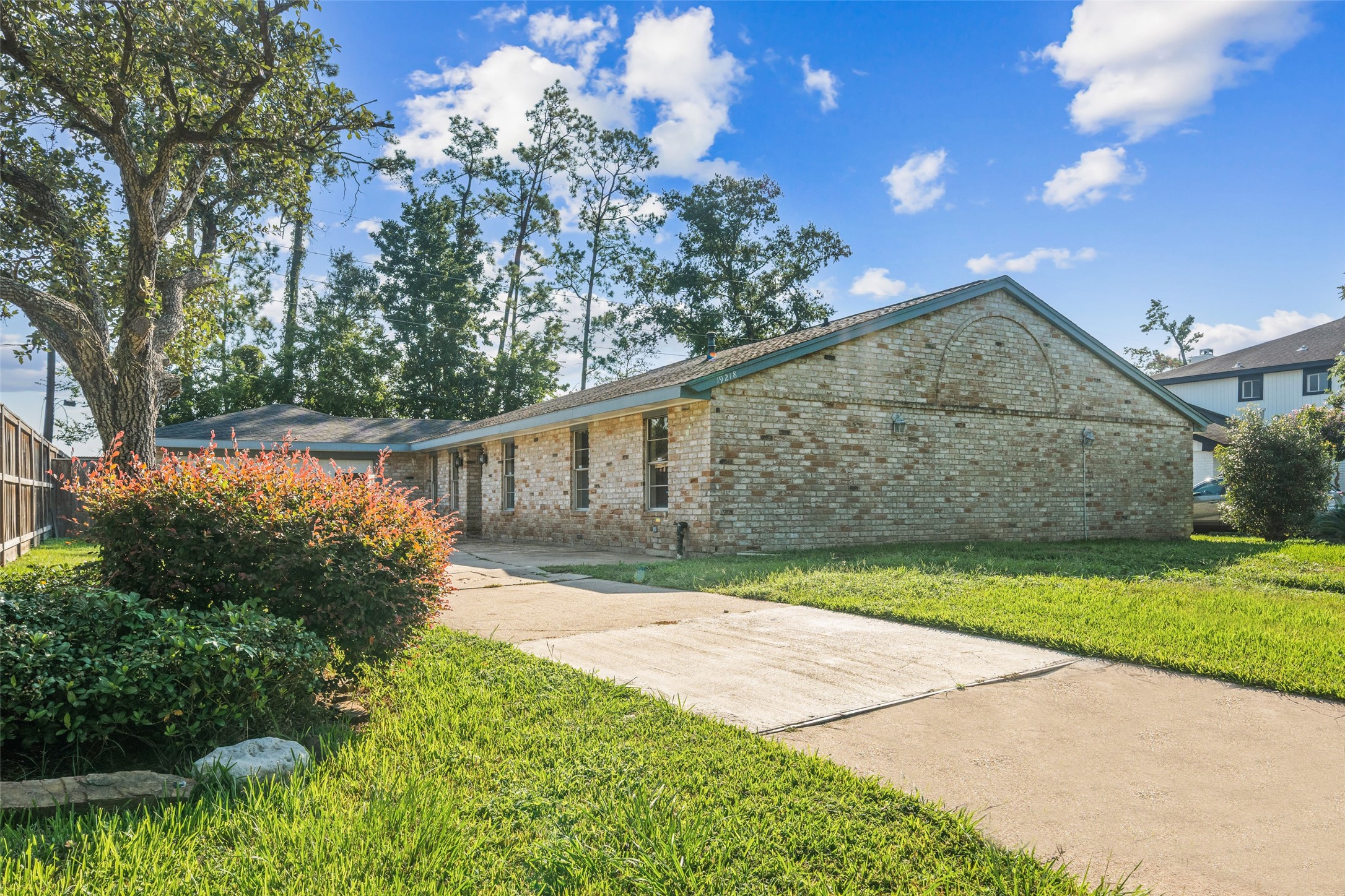 a backyard of a house with lots of green space and outdoor seating
