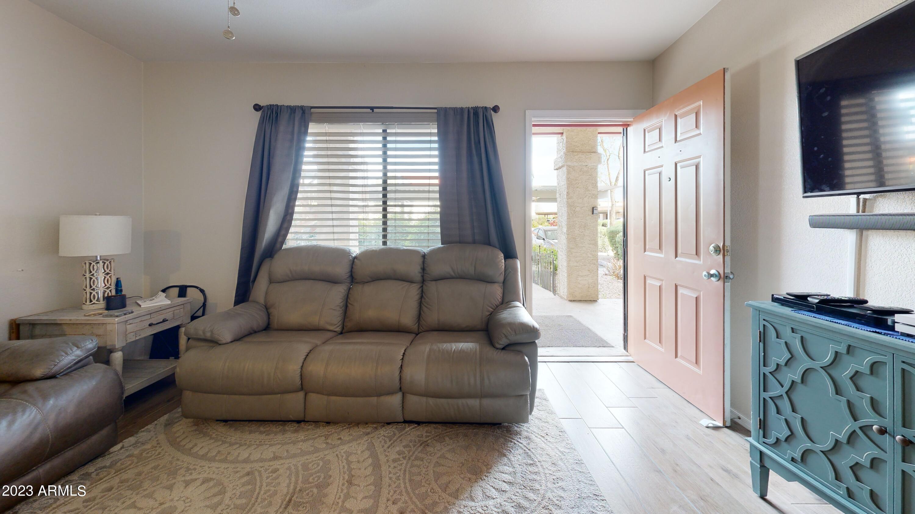 1440 North Idaho Road, Unit 1098 Apache Junction, AZ 85119 - Photo 5 of 10 a living room with furniture and a window