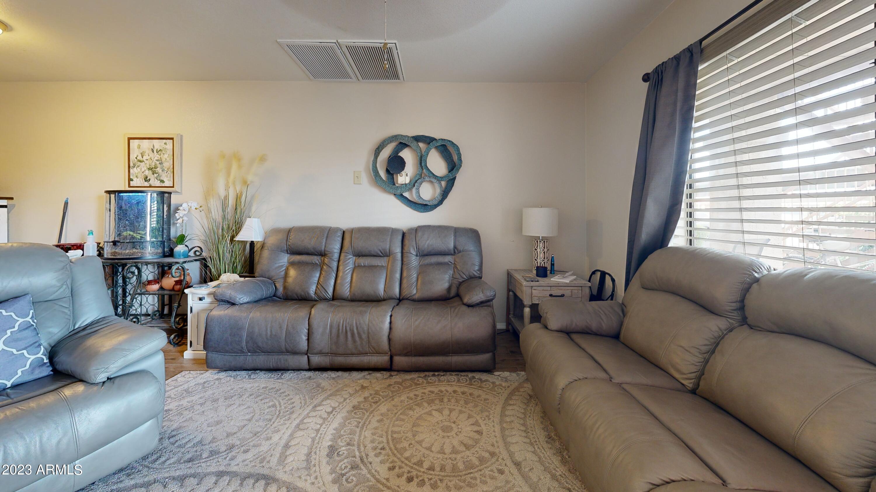1440 North Idaho Road, Unit 1098 Apache Junction, AZ 85119 - Photo 6 of 10 a living room with furniture and a window