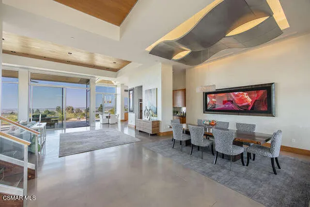 a open kitchen with stainless steel appliances granite countertop a stove and white cabinets