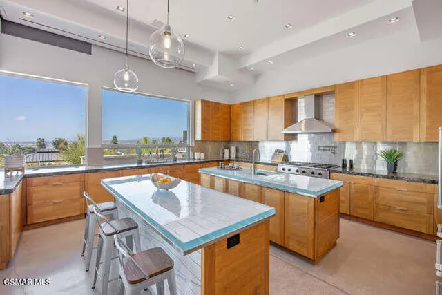 a bathroom with a granite countertop toilet a sink and a mirror