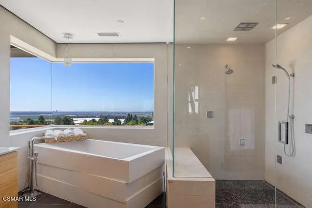 a bathroom with a granite countertop sink a toilet and shower