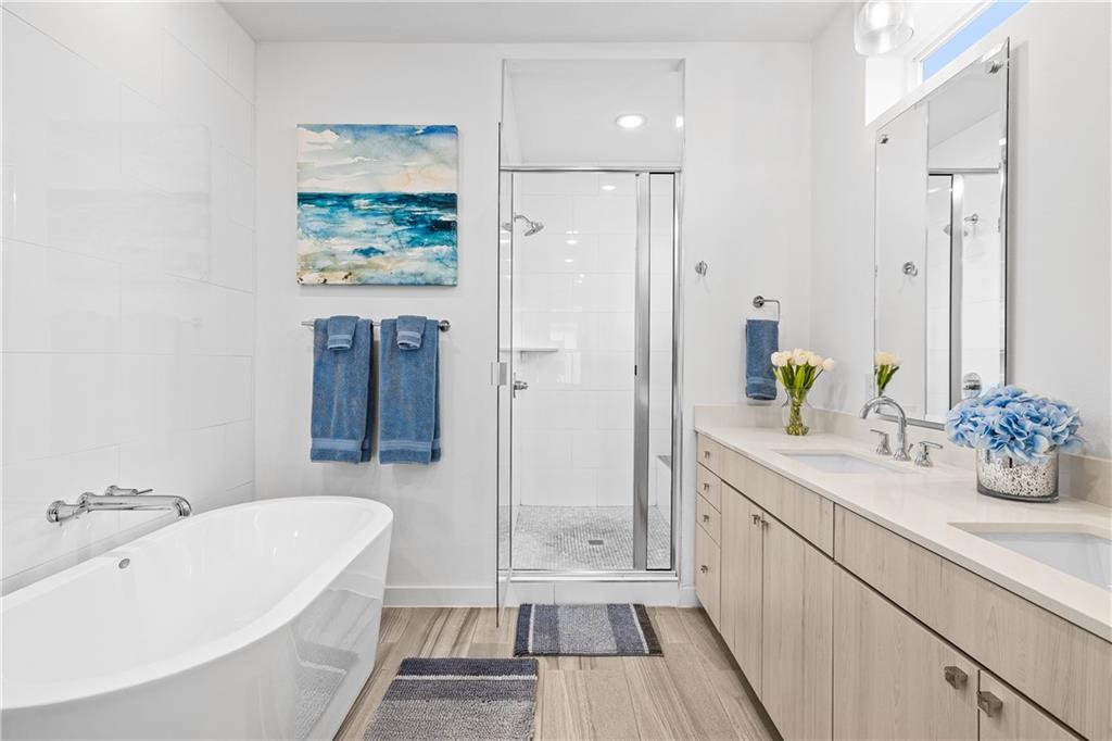 2624 Metcalfe Road, Unit 8 Austin, TX 78741 - Photo 14 of 32 This spacious master bathroom has dual vanities, a large free-standing soaking tub and an enormous walk-in shower.