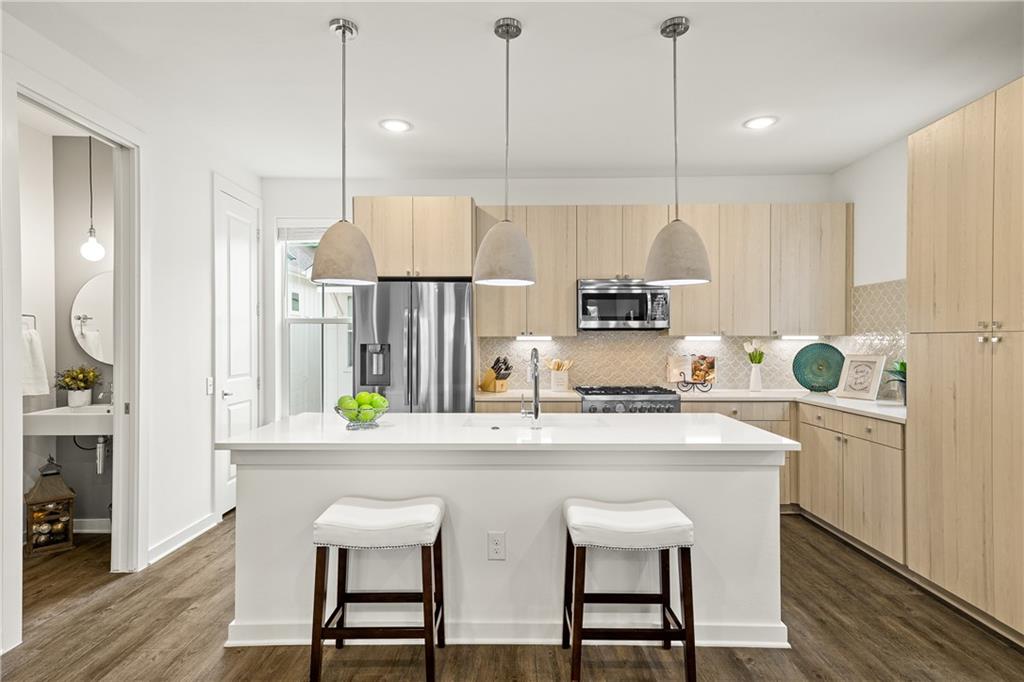 2624 Metcalfe Road, Unit 8 Austin, TX 78741 - Photo 2 of 32 The half bath is just off the kitchen. The pantry door can be seen in far left corner next to the window by the refrigerator.