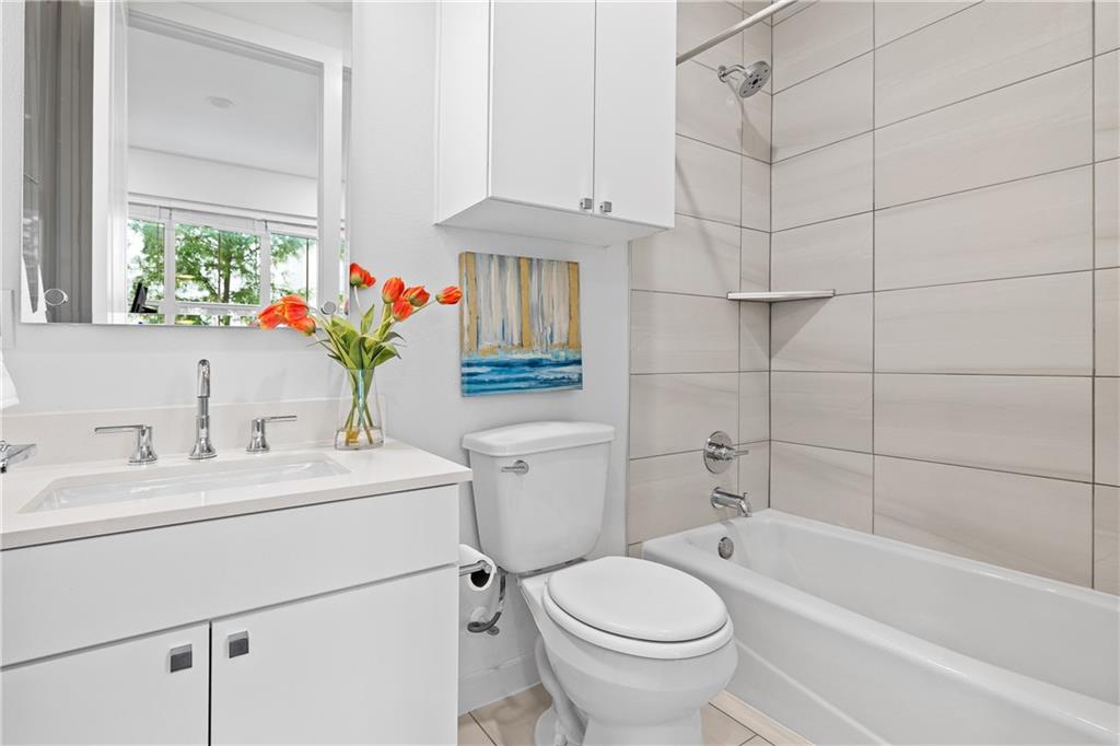2624 Metcalfe Road, Unit 8 Austin, TX 78741 - Photo 20 of 32 Full bathroom #1 is located inside bedroom #1 on the first floor. To the left of the sink is a reach-in closet (not pictured).
