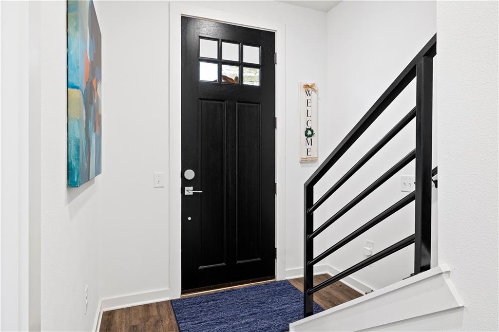 2624 Metcalfe Road, Unit 8 Austin, TX 78741 - Photo 22 of 32 Just inside the front entryway is a bedroom on the left with it’s own private ensuite full bathroom. Opposite the front door is the door to the 2-car enclosed garage (not pictured).