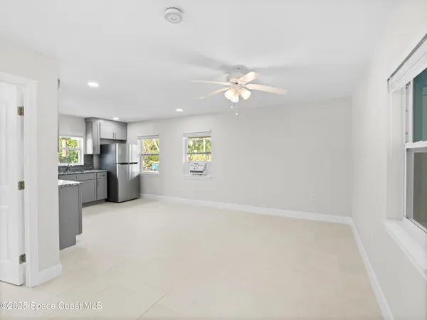 a kitchen with stainless steel appliances kitchen island a refrigerator sink and cabinets