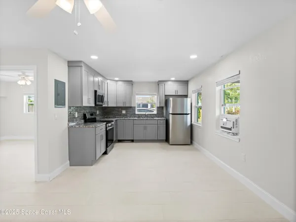 a kitchen with a refrigerator stove and microwave