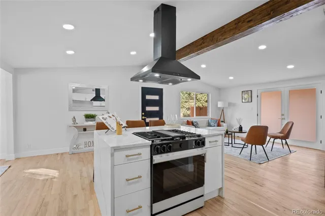 a kitchen with stainless steel appliances granite countertop a stove and a wooden floors