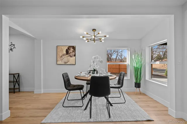 a view of a dining room with furniture wooden floor and a chandelier