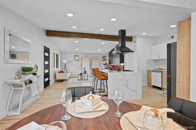 a living room with furniture and kitchen view