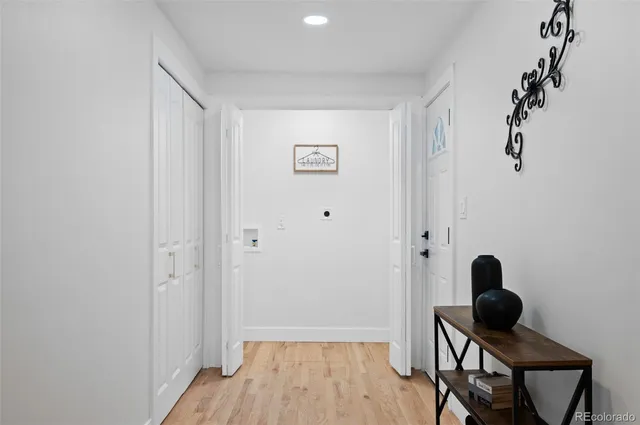 a view of a workspace room with wooden floor and bathroom