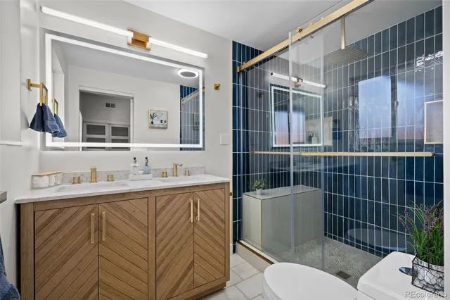 a bathroom with a toilet sink vanity and mirror