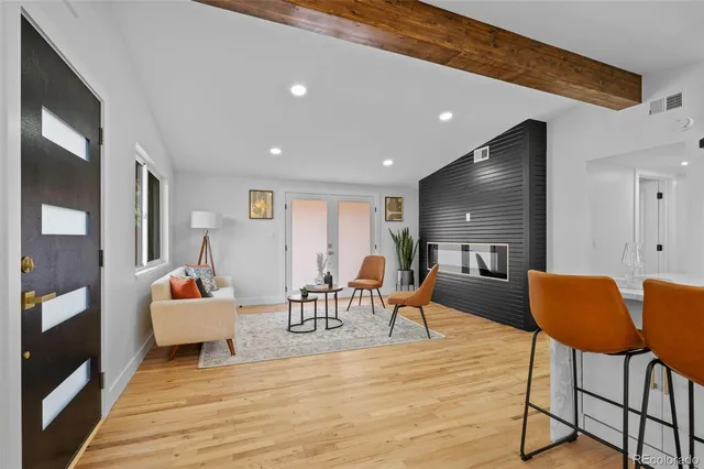 a living room with furniture and a wooden floor