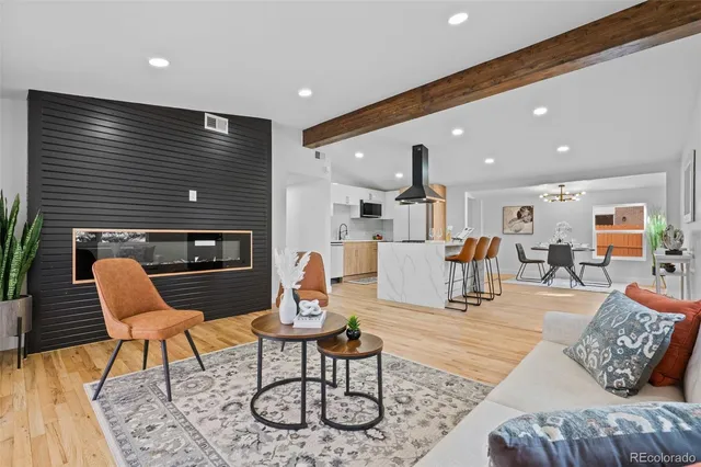 a living room with furniture and kitchen view