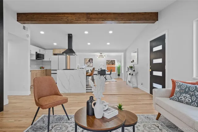 a living room with furniture and kitchen view