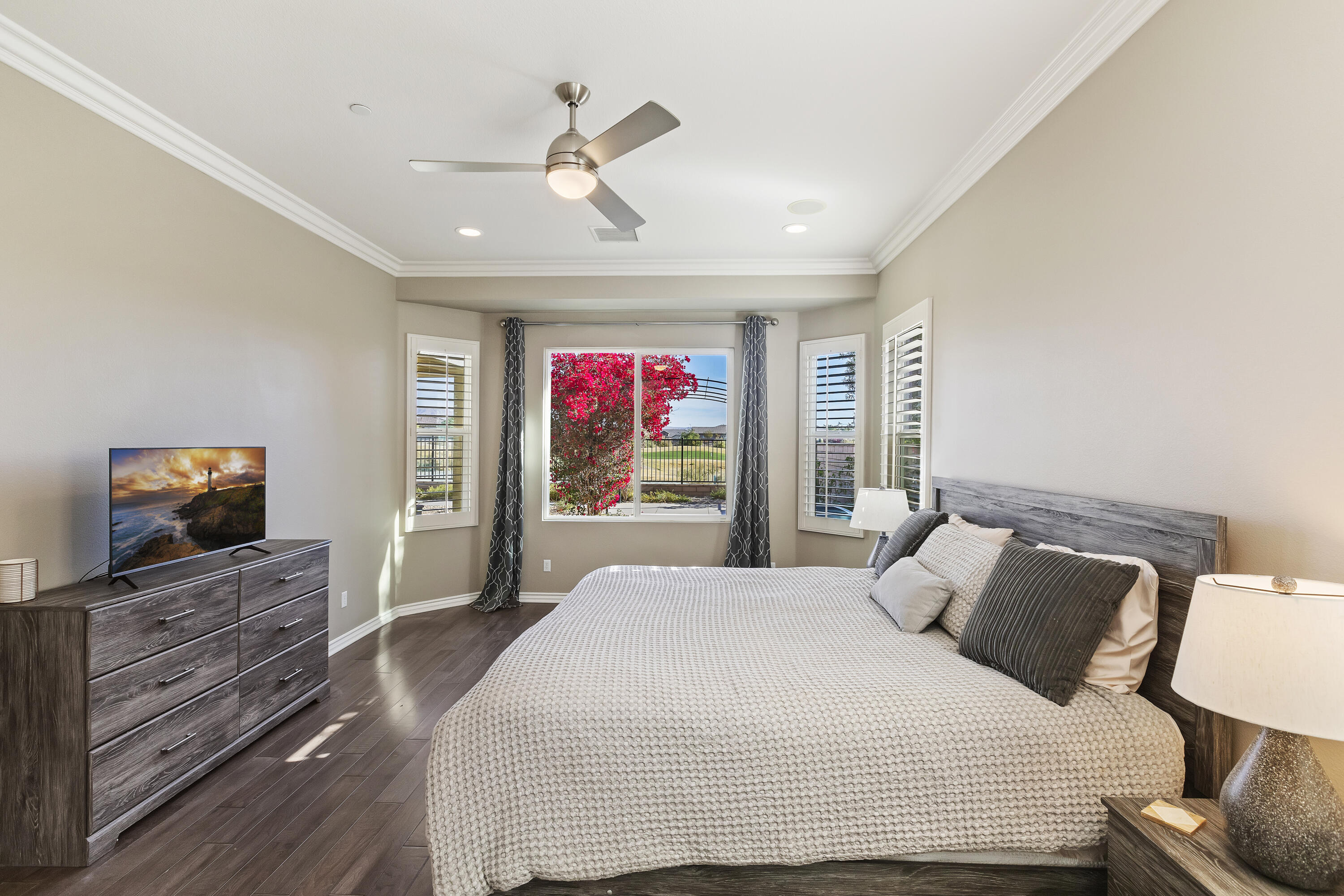 43020 Ascona Lane Indio, CA 92203 - Photo 17 of 33 a bedroom with a bed and dresser with mirror