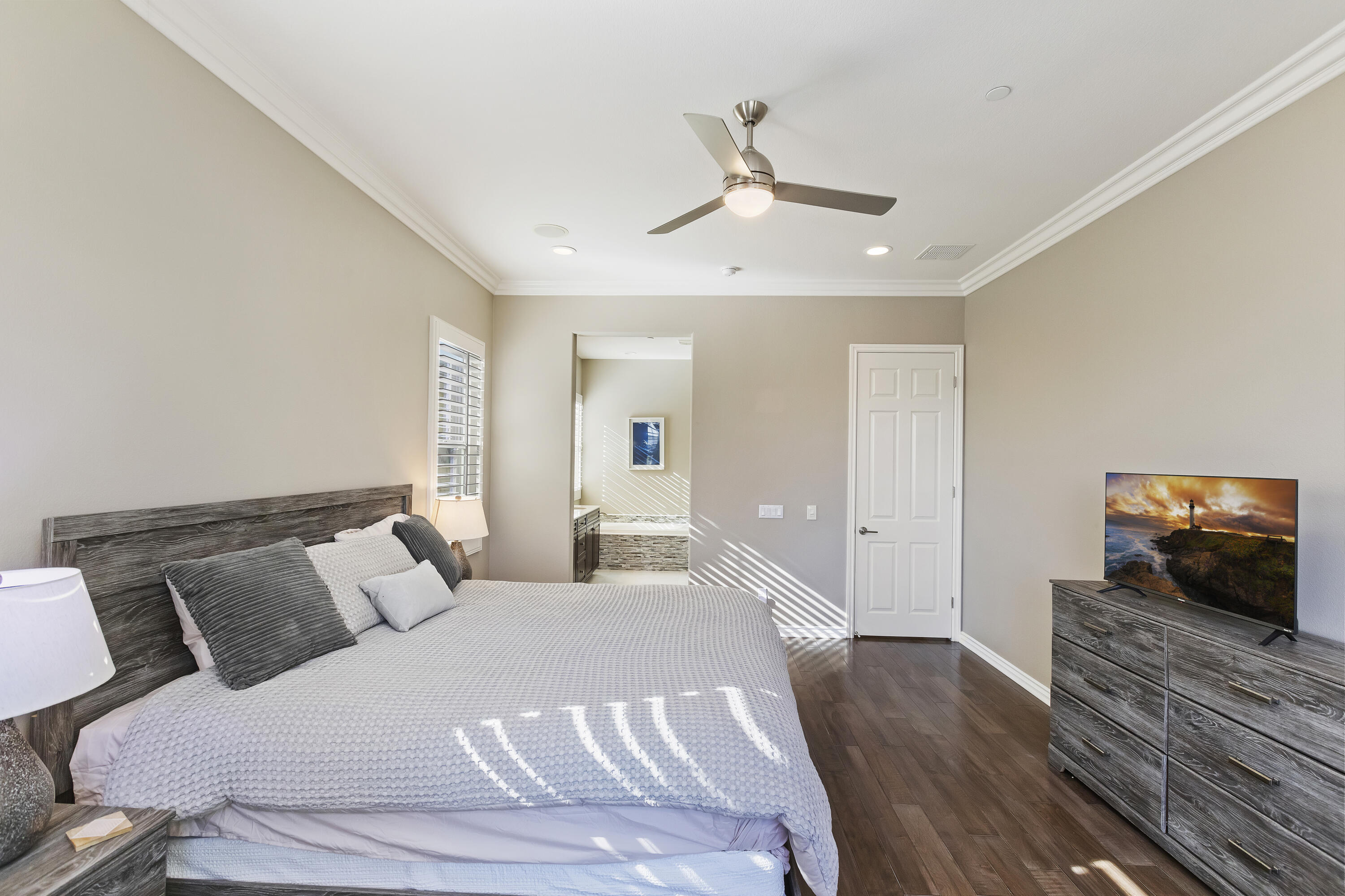 43020 Ascona Lane Indio, CA 92203 - Photo 19 of 33 a bedroom with a bed and wooden floor