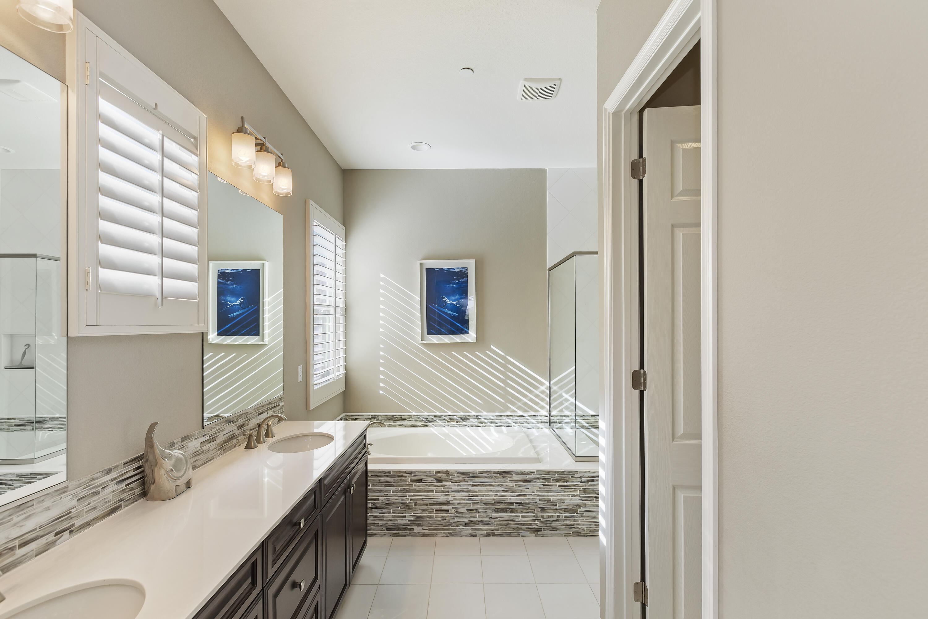 43020 Ascona Lane Indio, CA 92203 - Photo 20 of 33 a bathroom with a granite countertop sink and a mirror