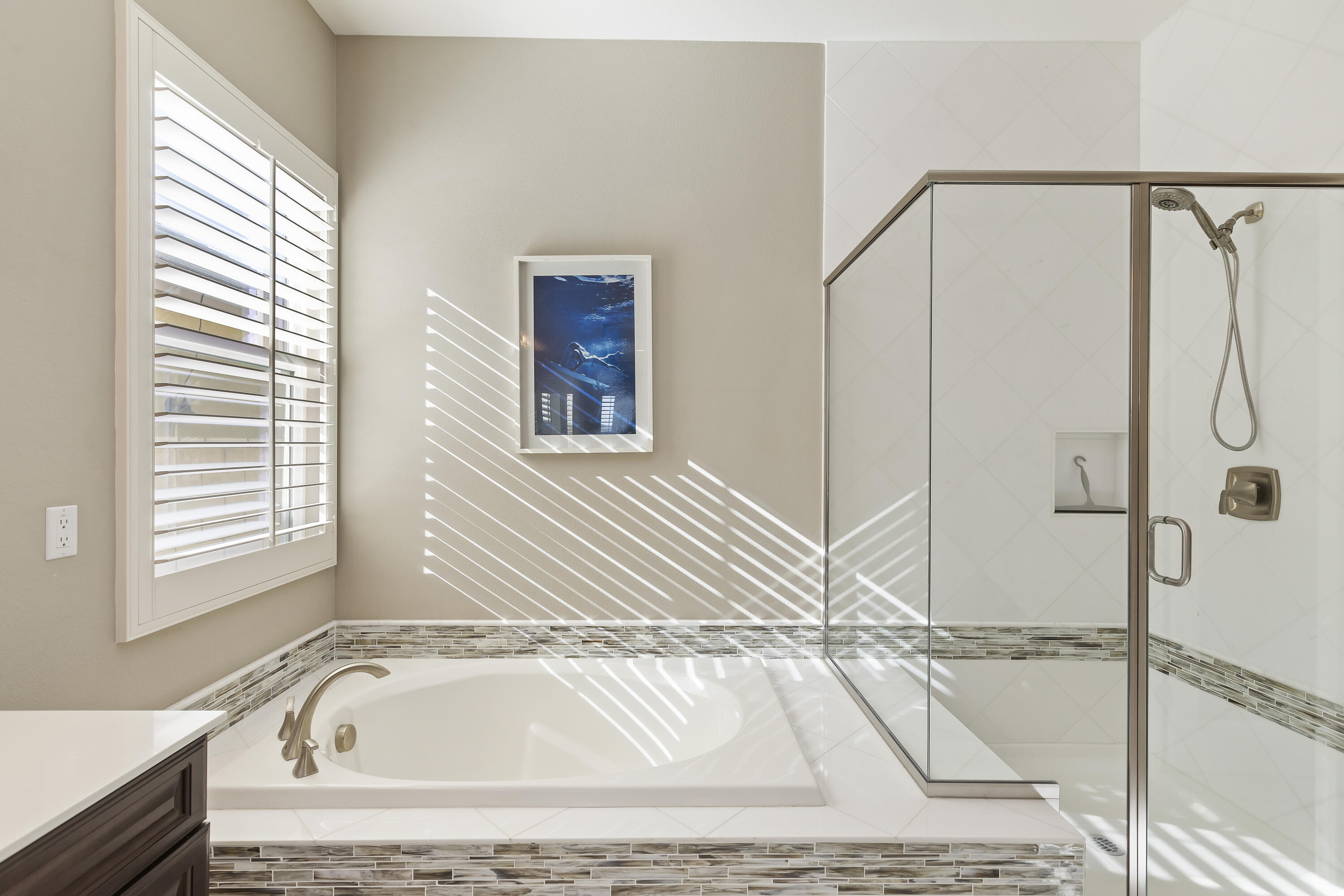 43020 Ascona Lane Indio, CA 92203 - Photo 21 of 33 a bathroom with a tub a window and a shower