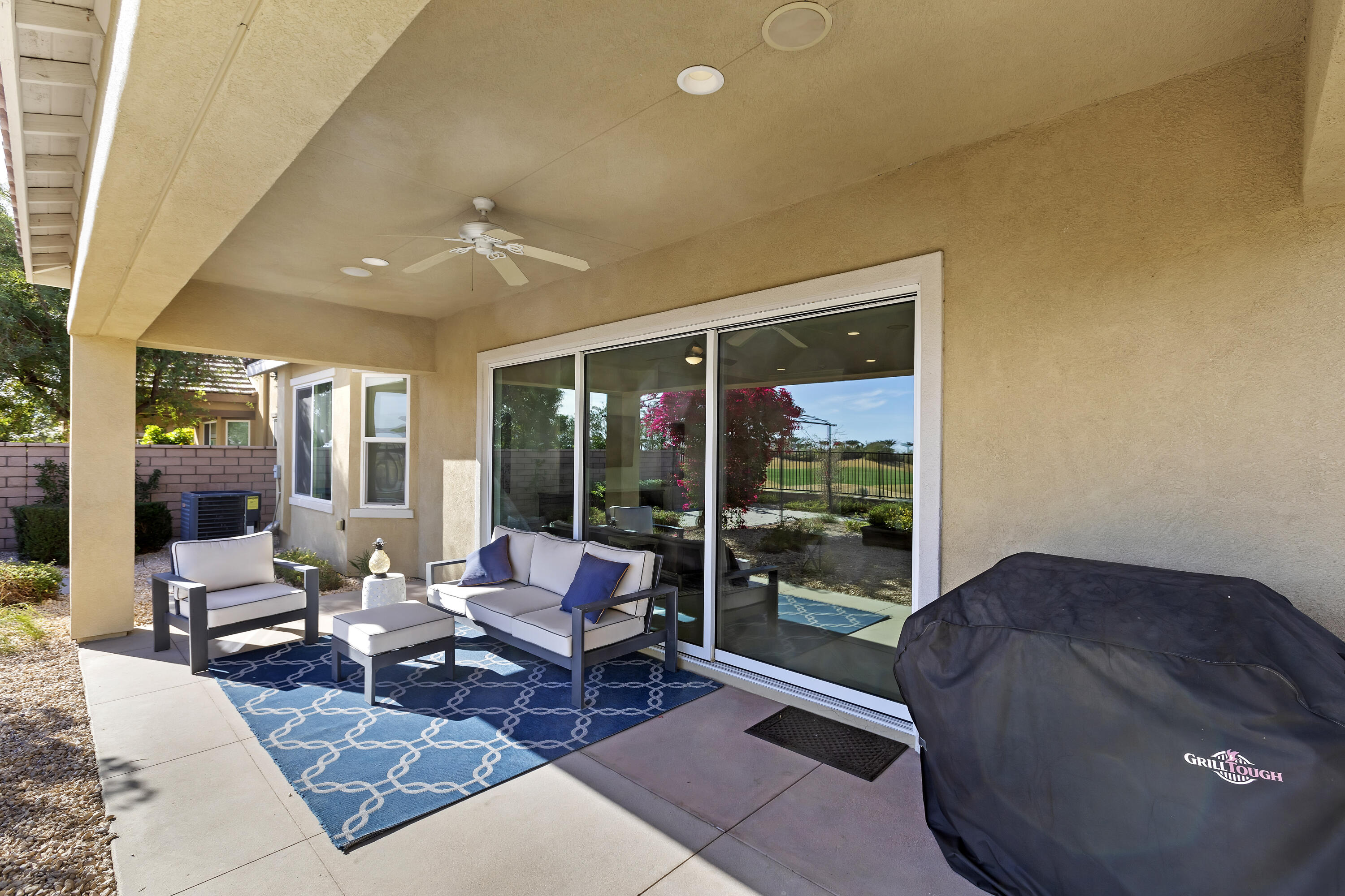 43020 Ascona Lane Indio, CA 92203 - Photo 26 of 33 a living room with furniture and floor to ceiling window